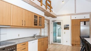 A kitchen with wooden cabinets, a dishwasher, and a built-in oven.