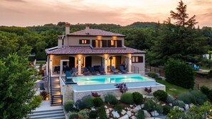 A two-story house with a swimming pool, surrounded by a landscaped garden and a forested hillside. - Villa With Pool Surrounded by Woods in Labin (Labin)