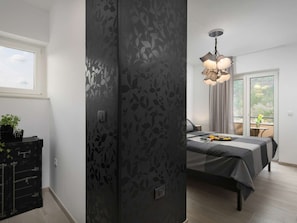 A modern bedroom with a bed, a desk, and a window. - Villa With Pool Surrounded by Woods in Labin (Labin)