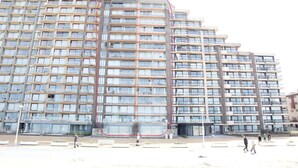 A multi-story building with a uniform facade, large windows, and balconies. - Apartment in Nieuwpoort Near the Beach (Nieuwpoort)