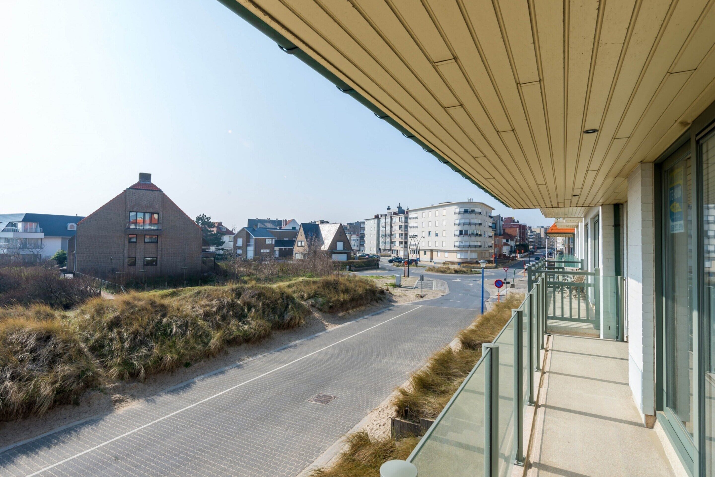 A coastal road with buildings in the background.