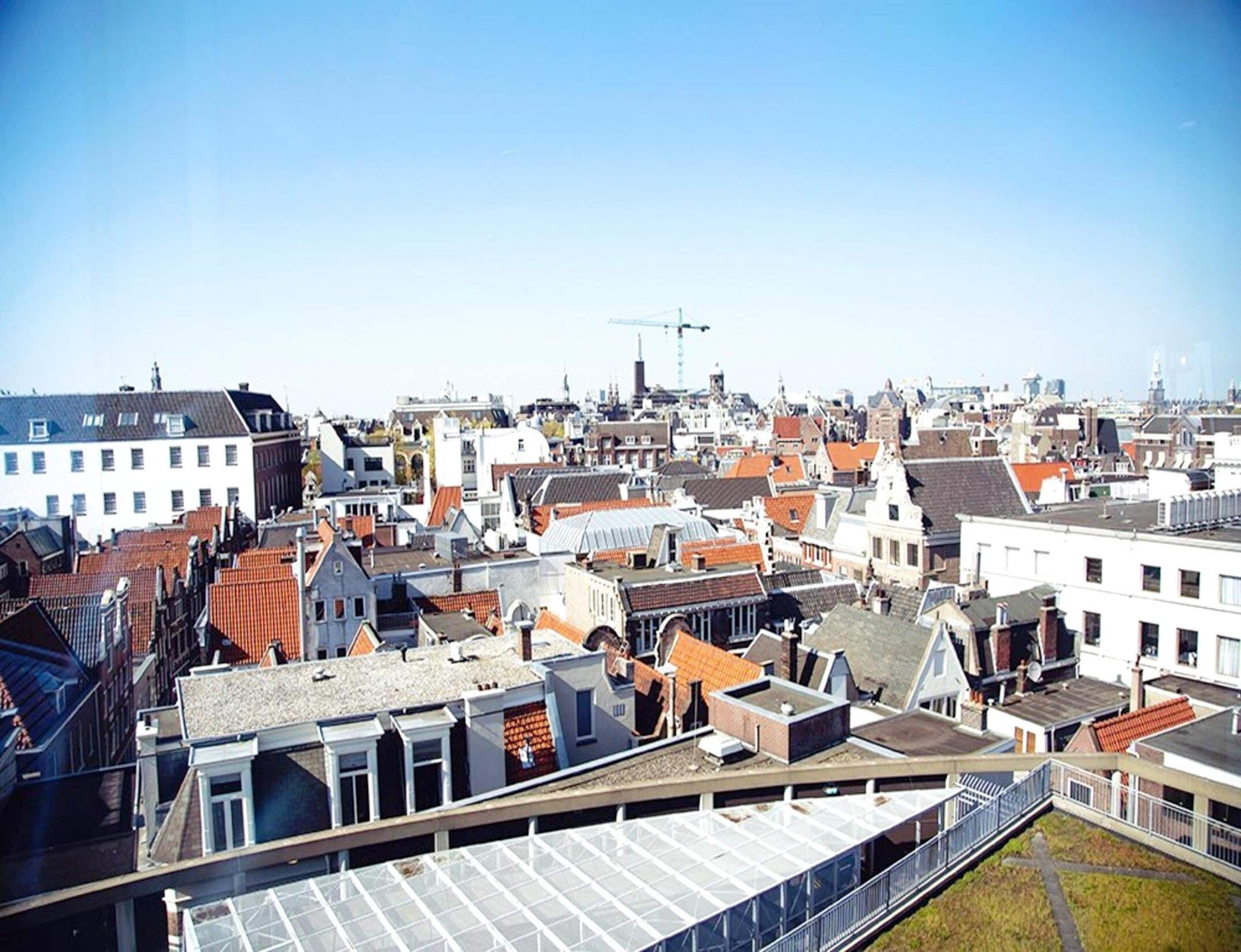 A densely packed urban area with a variety of building styles and a clear sky.