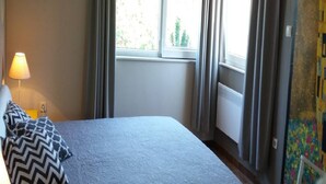 A bedroom with a bed, curtains, a window, a radiator, and a lamp. - Apartments Villa Dona -two Bedroom Apartment With Shared Swimming Pool (Vela Luka)