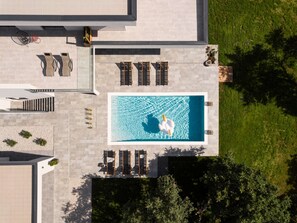 An aerial view of a modern building with a swimming pool, outdoor seating, and a well-maintained lawn. - Tasteful Villa in Labin With Private Outdoor Pool (Labin)
