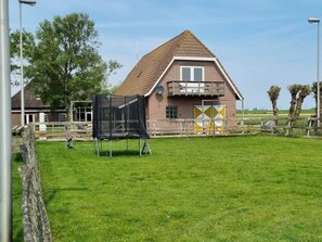A brick building with a triangular roof and a balcony. - Country Life Comfortable Holiday Residence (t Zand)