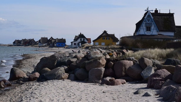 A coastal village with traditional houses by the sea, featuring thatched roofs and a rocky shoreline. - Dune View No. 3 Comfortable Vacation Home (Heiligenhafen)