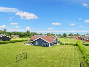 A residential area with multiple houses, a well-maintained lawn, and a soccer goal. - 4 Star Holiday Home in Nordborg (Nordborg)