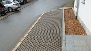 A paved area with a patterned surface, adjacent to a curb and a sidewalk. - Rebenrain Comfortable Holiday Residence (Steinach)