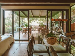 A sunlit patio with a dining table, chairs, and a sofa. - Country House in Gran Canaria With Private Pool (Vega de San Mateo)