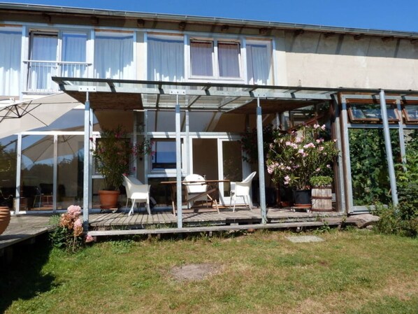 A two-story house with a covered patio area. - Toad 5 on the Soederbring (Waddeweitz)
