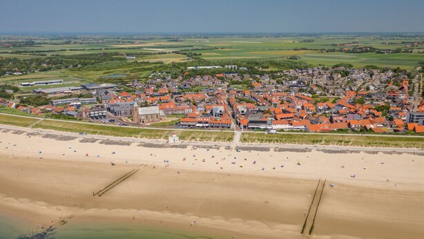 An aerial view of a coastal town with a beach, houses, and a church. - Zoutelande Retreat by Sea (Zoutelande)