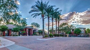 Una zona residencial con senderos pavimentados y palmeras.