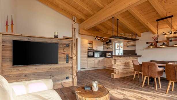 A modern kitchen with wooden cabinets and a built-in oven. - Luxury Chalet With Private Sauna in Uttendorf (Uttendorf)