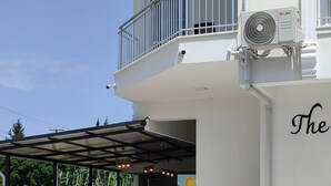 A building with a balcony, outdoor seating, and a staircase leading to the entrance. - The Dalaman Suites & Pension Dalaman Airport 10 km (Dalaman)