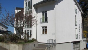 A white building with a large window and a balcony. - In the Villa Granitz (Göhren)
