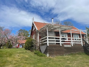 A wooden house with a red-tiled roof and a white balcony. - 4 Star Holiday Home in Ronneby (Ronneby)