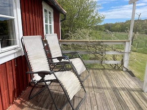 A wooden deck with two reclining chairs and a small table. - 4 Star Holiday Home in Ronneby (Ronneby)