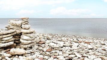 A rocky beach with a stack of stones.