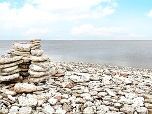 A rocky beach with a stack of stones. - 5 Star Holiday Home in Lottorp (Löttorp)