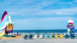 A beach with colorful chairs and two large sculptures. - Holiday Villa Novaworld Phan Thiet (Tien Thanh)
