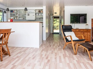 A modern kitchen with white cabinets, a wooden island, and pendant lighting. - 6 Person Holiday Home in Ulfborg (Ulfborg)