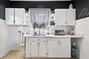Fridge, microwave, coffee/tea maker, cookware/dishes/utensils