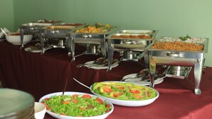 Une table de buffet avec divers plats et ustensiles de service.