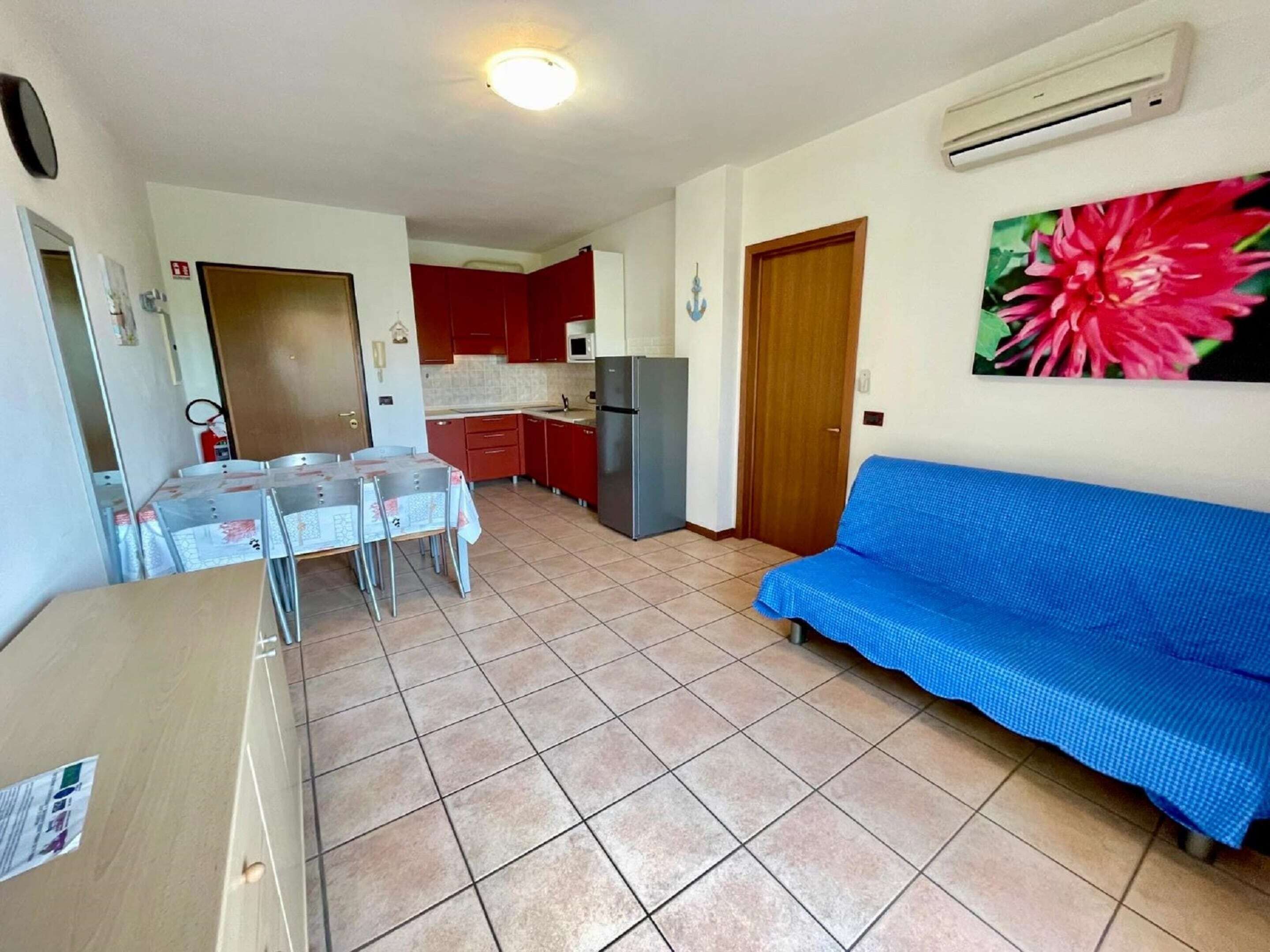 A compact living space with a kitchenette, a dining area, and a sofa.