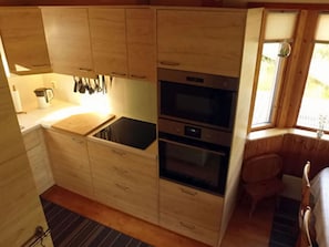 Apartment | Private kitchen | Oven, toaster, high chair - Holiday Home by the Lake (Tived)
