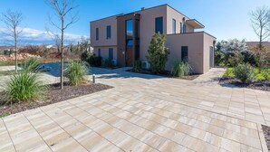 A modern two-story house with a spacious patio area. - Family Apartment in Novigrad (Brtonigla)