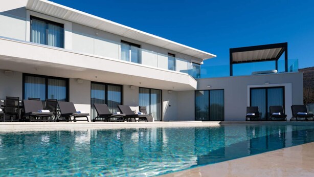 A modern hotel with a swimming pool, sun loungers, and a covered outdoor area. - Lea Comfortable Holiday Residence (Rasa)