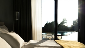 A hotel room with a bed, a view of a swimming pool, and a patio area. - Lea Comfortable Holiday Residence (Rasa)