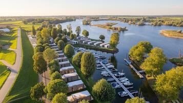 A riverside hotel with multiple buildings, a marina, and boats.