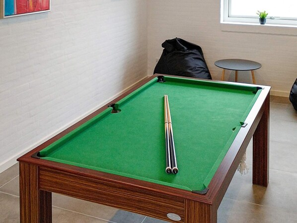 A pool table with a green felt surface and a pool cue in the center. - 12 Person Holiday Home in Lemvig (Lemvig)