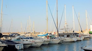 A marina with multiple sailboats docked. - Belvilla by OYO Aldea Marina (Garrucha)