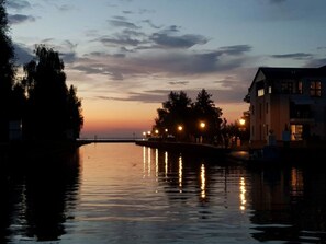 A calm river at dusk with a bridge and buildings on the right. - "penthouse Apartment on the Water" (Rechlin)