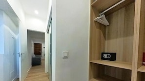 A hallway with wooden flooring, a closet with shelves, and a door leading to another room. - Apartment in Puerto del Rosario Near Playa Chica (Puerto del Rosario)