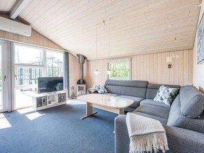 A cozy living room with a sofa, a coffee table, and a television. - 4 Person Holiday Home in Hemmet (Hemmet)