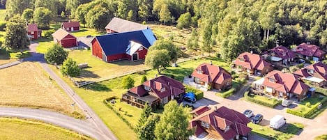 A residential area with multiple houses, a barn, and a road.