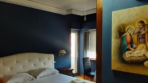 A bedroom with a large bed, a nightstand, a chair, and a painting on the wall. - Holiday Home in Pizzo Near Tyrrhenian Sea (Pizzo)