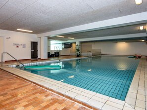 An indoor swimming pool with tiled walls and a wooden floor. - 6 Person Holiday Park Home in Glesborg (Glesborg)