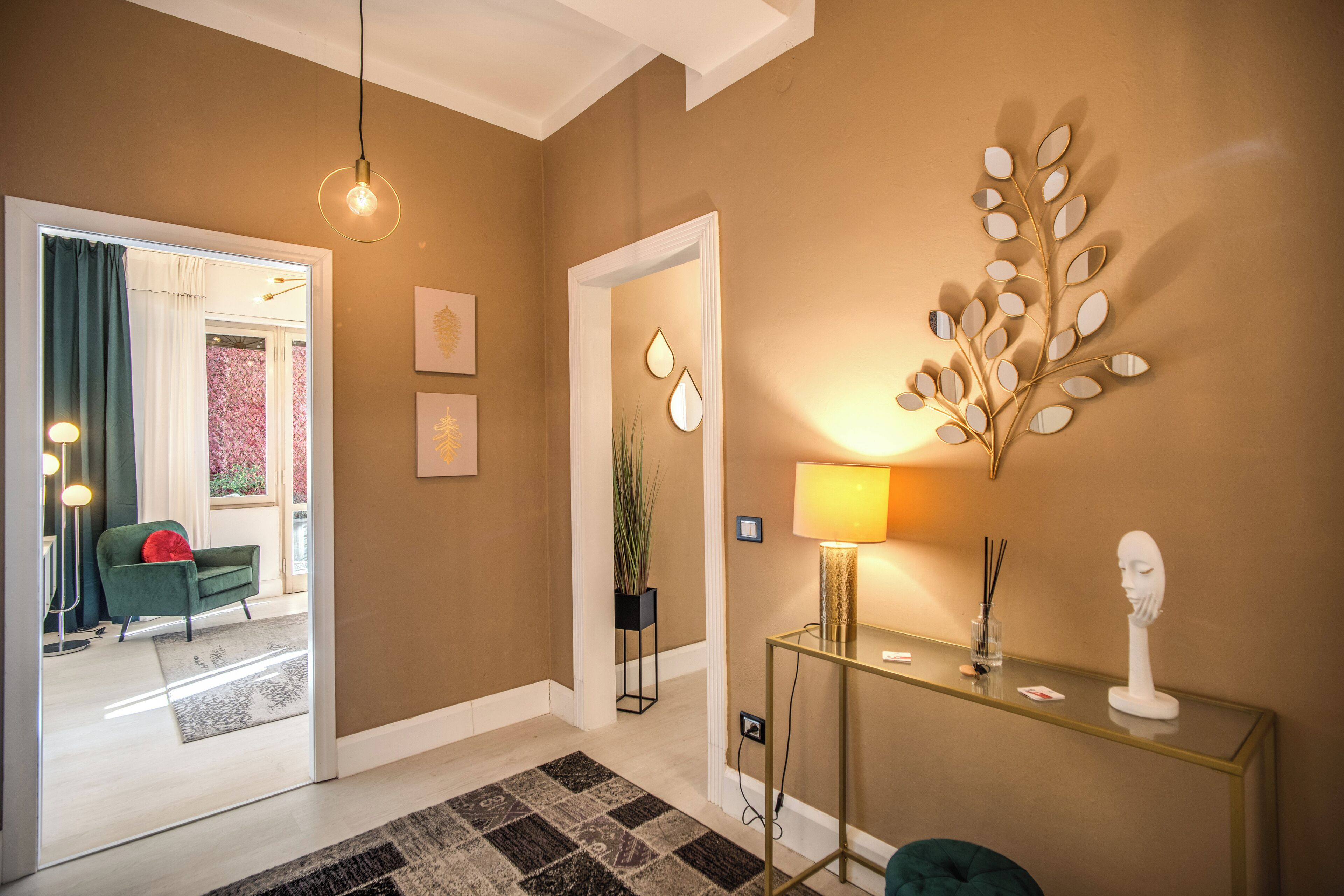 A modern interior with a console table, a wall-mounted mirror, and a decorative plant.