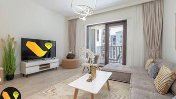 Luxury Apartment | Living area | 65-inch Smart TV with cable channels