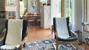 A cozy living room with two armchairs, a dining table, and a kitchen area. - 6 Person Holiday Home in Mardaklev-by Traum (Mårdaklev)