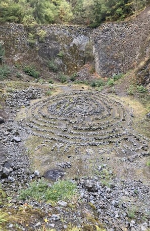 A spiral stone path in a rocky terrain with sparse vegetation. - Villa Birrenbach Comfortable Vacation Home (Walsdorf)