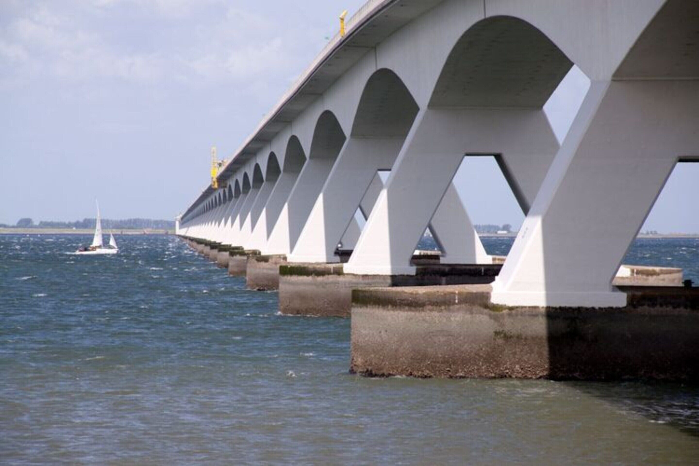 A bridge with multiple arches over a body of water.