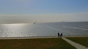 A wide, calm body of water with a clear sky. - Luetje Huuske Modern Retreat (Krummhoern)