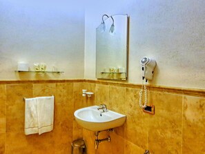A bathroom with a sink, mirror, towel rack, and hairdryer. - Apartment in Monteverdi Near Wine Tours (Monteverdi Marittimo)