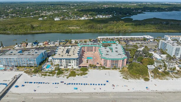 A coastal hotel with multiple buildings, a beach, and a marina. - Charming First Floor Condo at the Beach (Indian Shores)