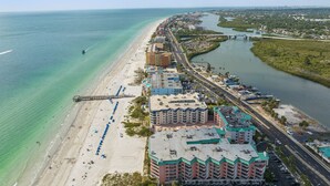 A coastal hotel with multiple buildings, a beach, and a river. - Charming First Floor Condo at the Beach (Indian Shores)